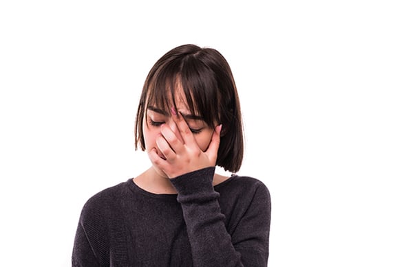 Frustrated young woman holding her head in her hands