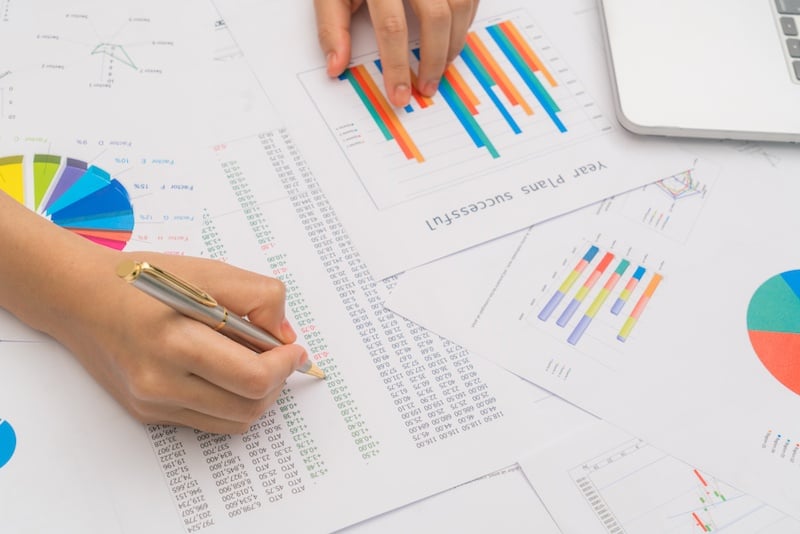 Reviewing the results of a market research study with pen and paper