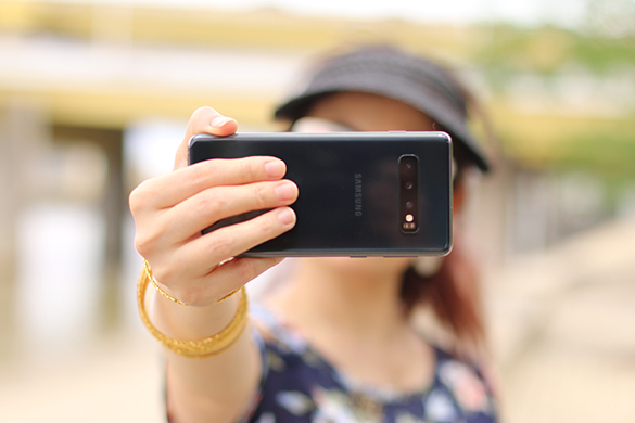 Woman taking selfie video with her phone